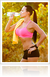 Woman drinking water during exercising