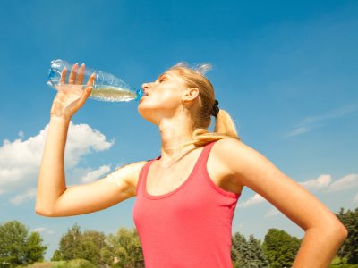 Athlete refreshing with bottle of water