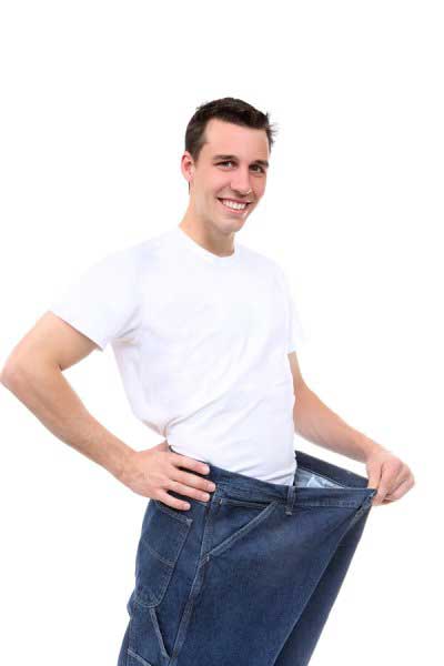Man after weight loss showing his jeans