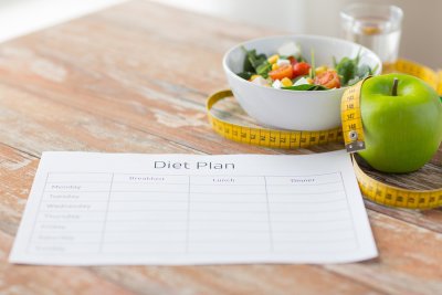 Diet plan and fruit on table