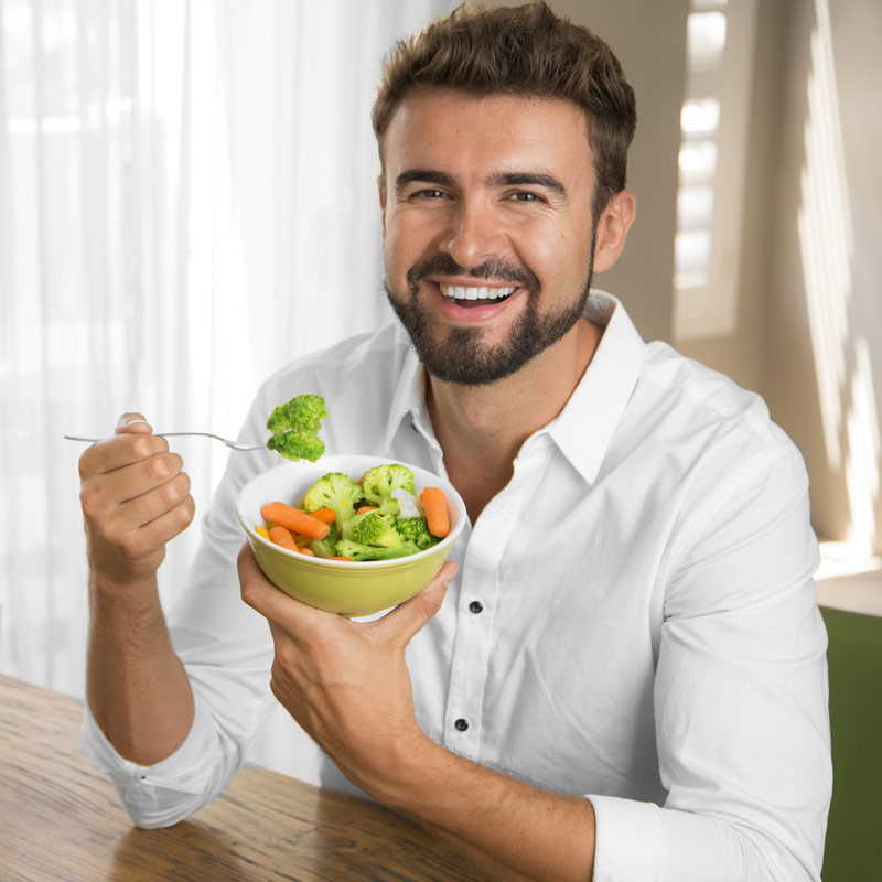 man eating vegetables